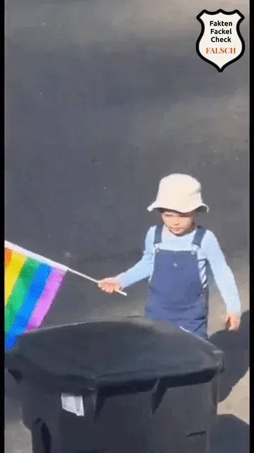 Standbild aus dem KI-generierten Video: ein Kind in Latzhose und Sonnenhut hält eine Regenbogenflagge und geht auf eine schwarze Mülltonne zu, versehen mit dem Faktenfackel-Störer 'Falsch'